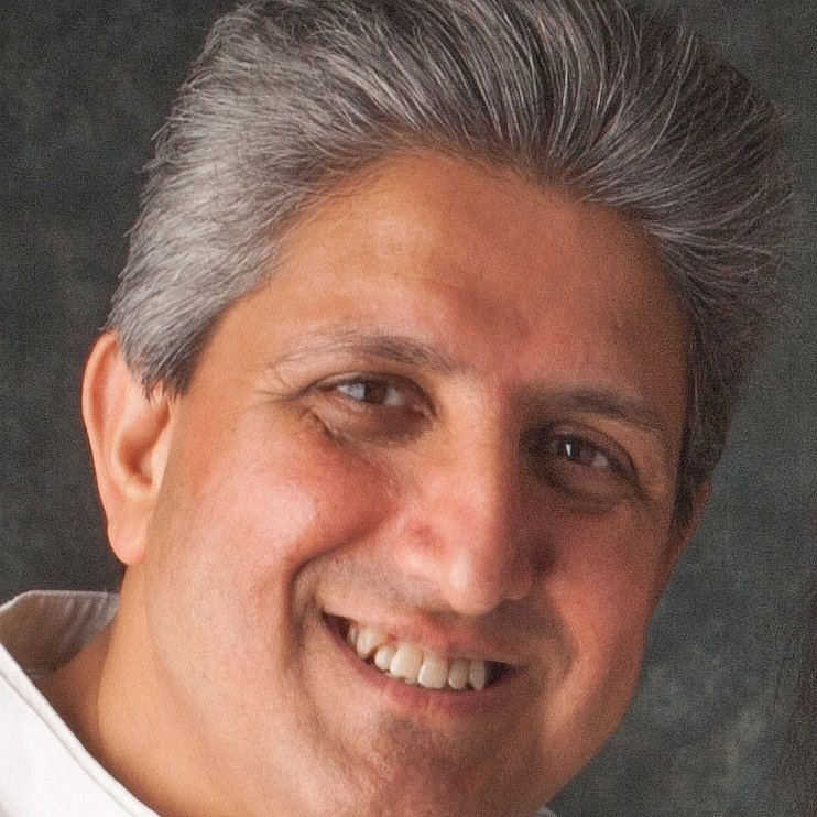 Portrait of Professor Minesh Khashu smiling.