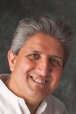 Portrait of Professor Minesh Khashu smiling.