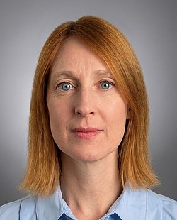 A professional headshot of Teresa Primavesi-Poggio with a confident look.