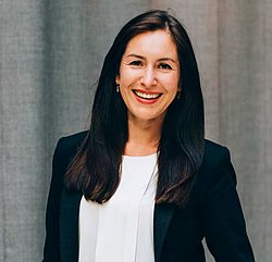 A professional headshot of Olga Antonava, smiling and dressed in business attire.