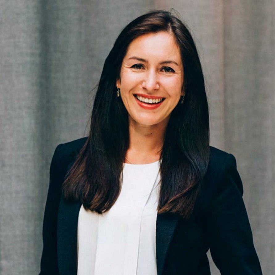 A professional headshot of Olga Antonava, smiling and dressed in business attire.