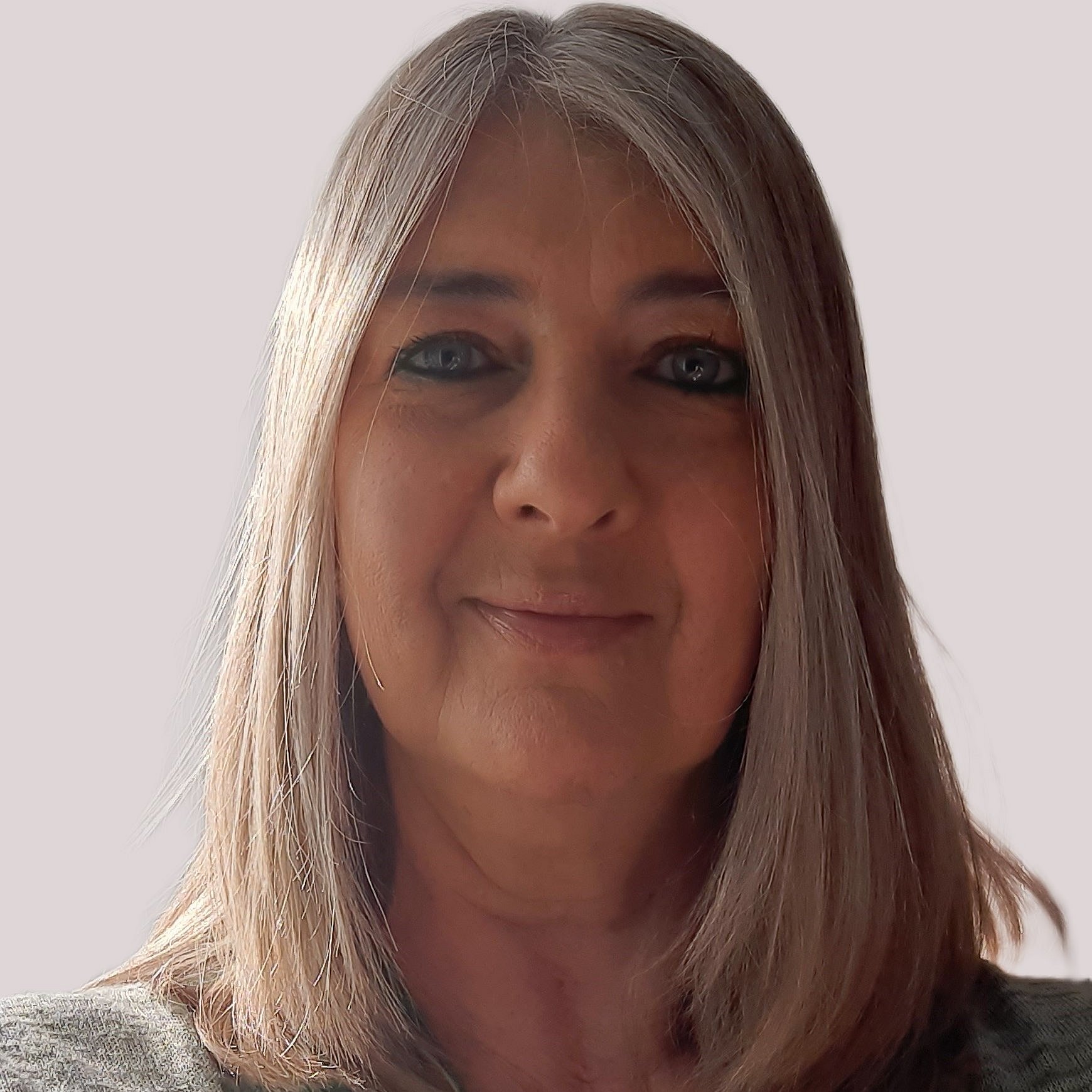 Portrait of Dr. Julia Petty smiling in front of a neutral background.