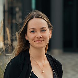 A professional portait headshot of Sonja Schäfer wearing a black jacket and necklace.