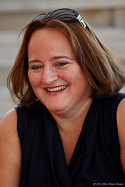 Portrait of Monique Oude Reimer smiling outdoors.