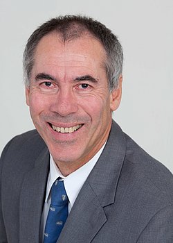 Portrait of Dr. Nicholas Lack in a suit and tie.