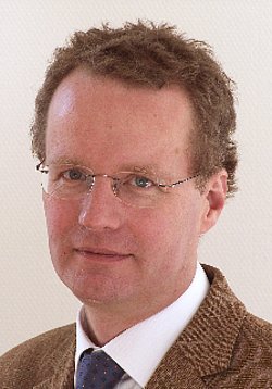 Portrait of Christian Poets with glasses and suit.