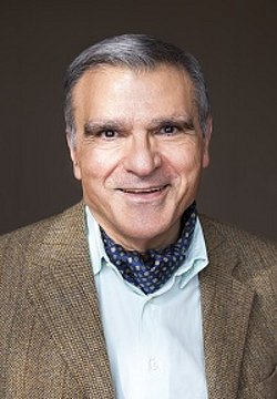 Portrait of Giuseppe Buonocore wearing a jacket and scarf.