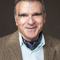 Portrait of Giuseppe Buonocore wearing a jacket and scarf.