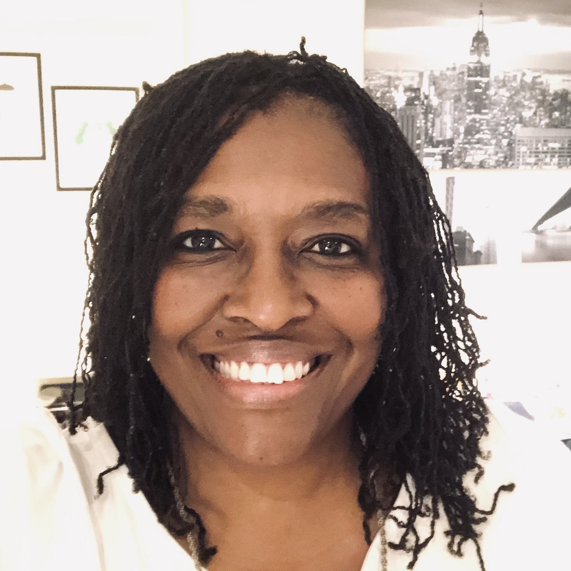 Professional Portrait of Gigi Khonyongwa-Fernandez smiling against a neutral background.