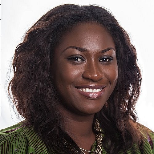 Portrait of Selina Bentoom smiling in a green blouse.