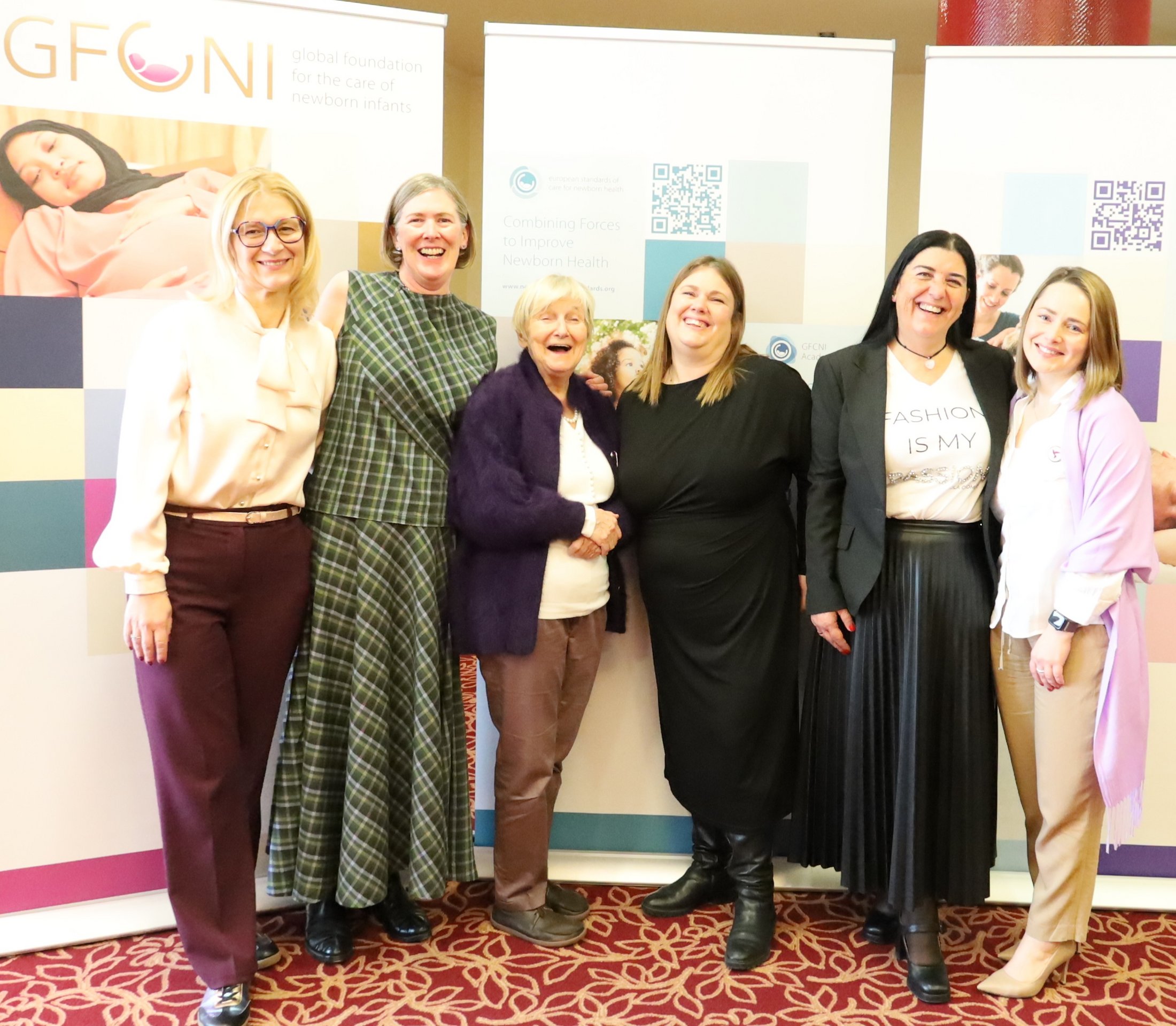 POS 2026 Day 3 Speakers – Peer Learning and Global Advocacy Group of speakers standing together in front of GFCNI banners at POS 2026, representing international parent organizations sharing peer learning experiences in newborn health.
