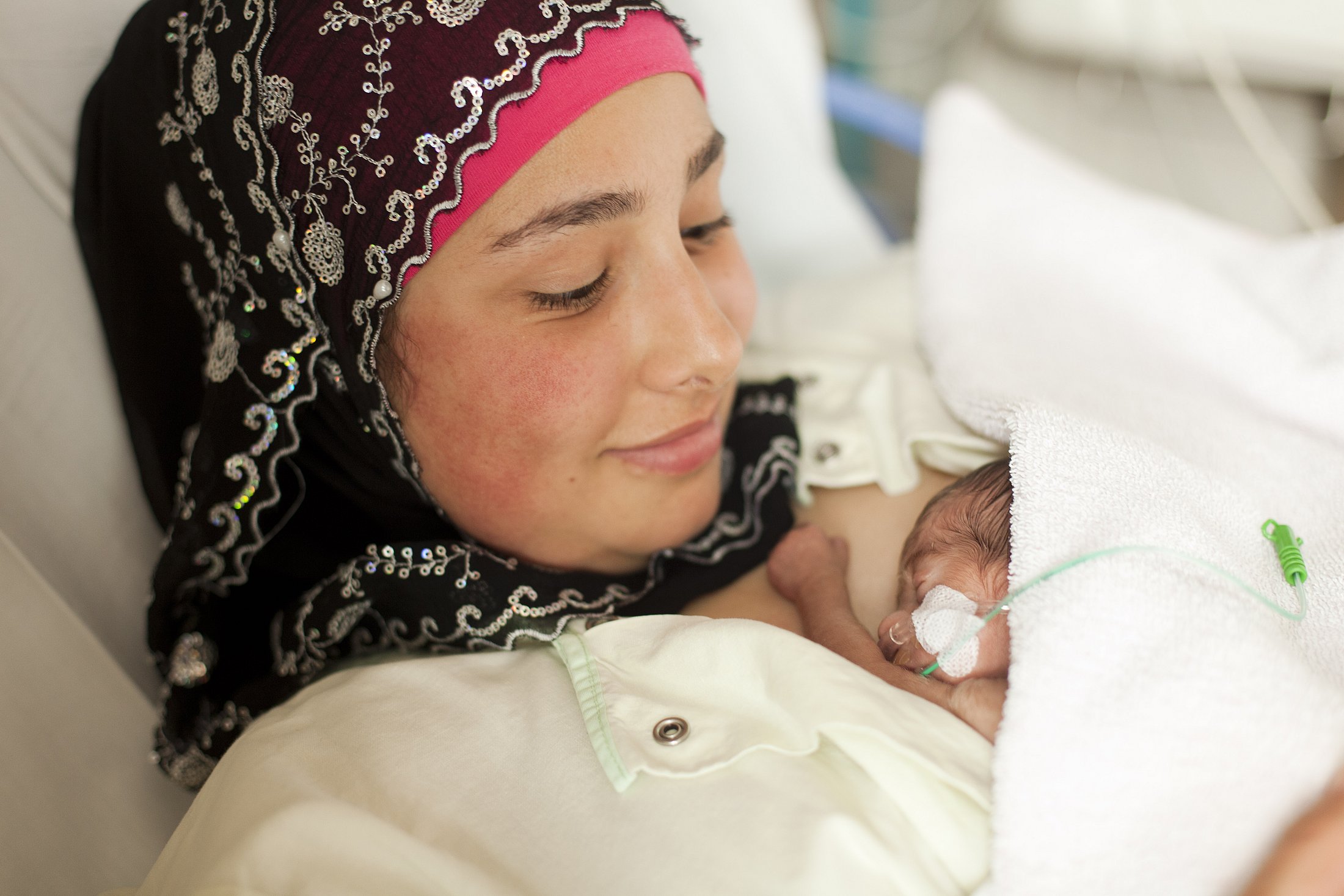 Mother with preterm infant in hospital bed