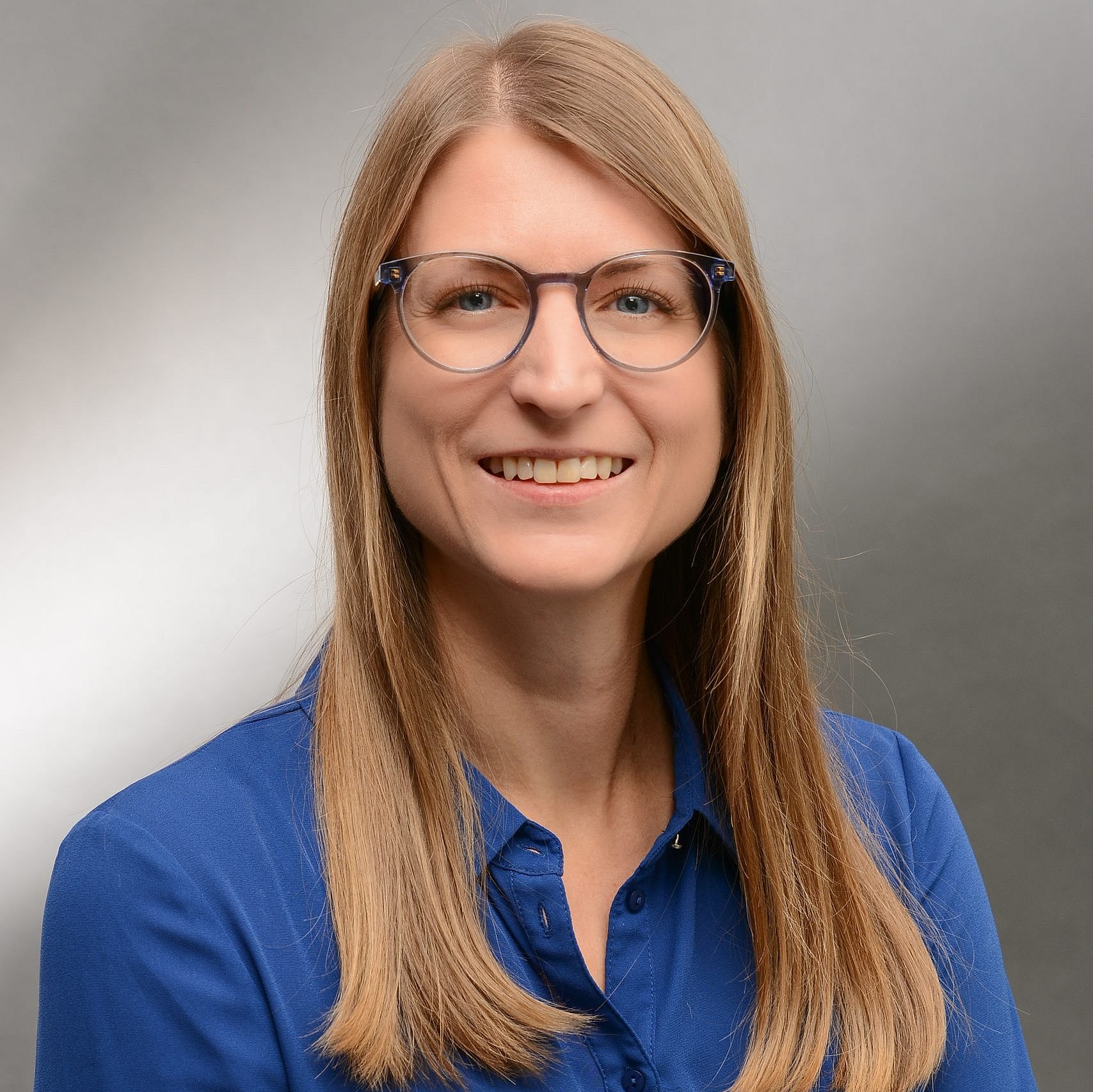 A professional headshot of Yvonne Willibald wearing a blue blouse.
