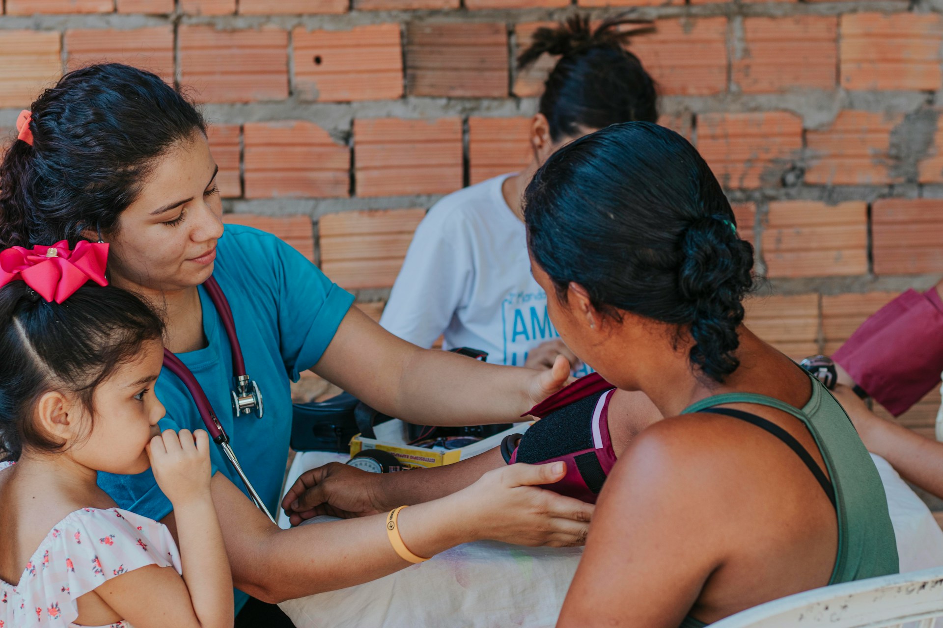Community blood pressure screening for preventive health Healthcare worker measuring a woman’s blood pressure during a community health visit.