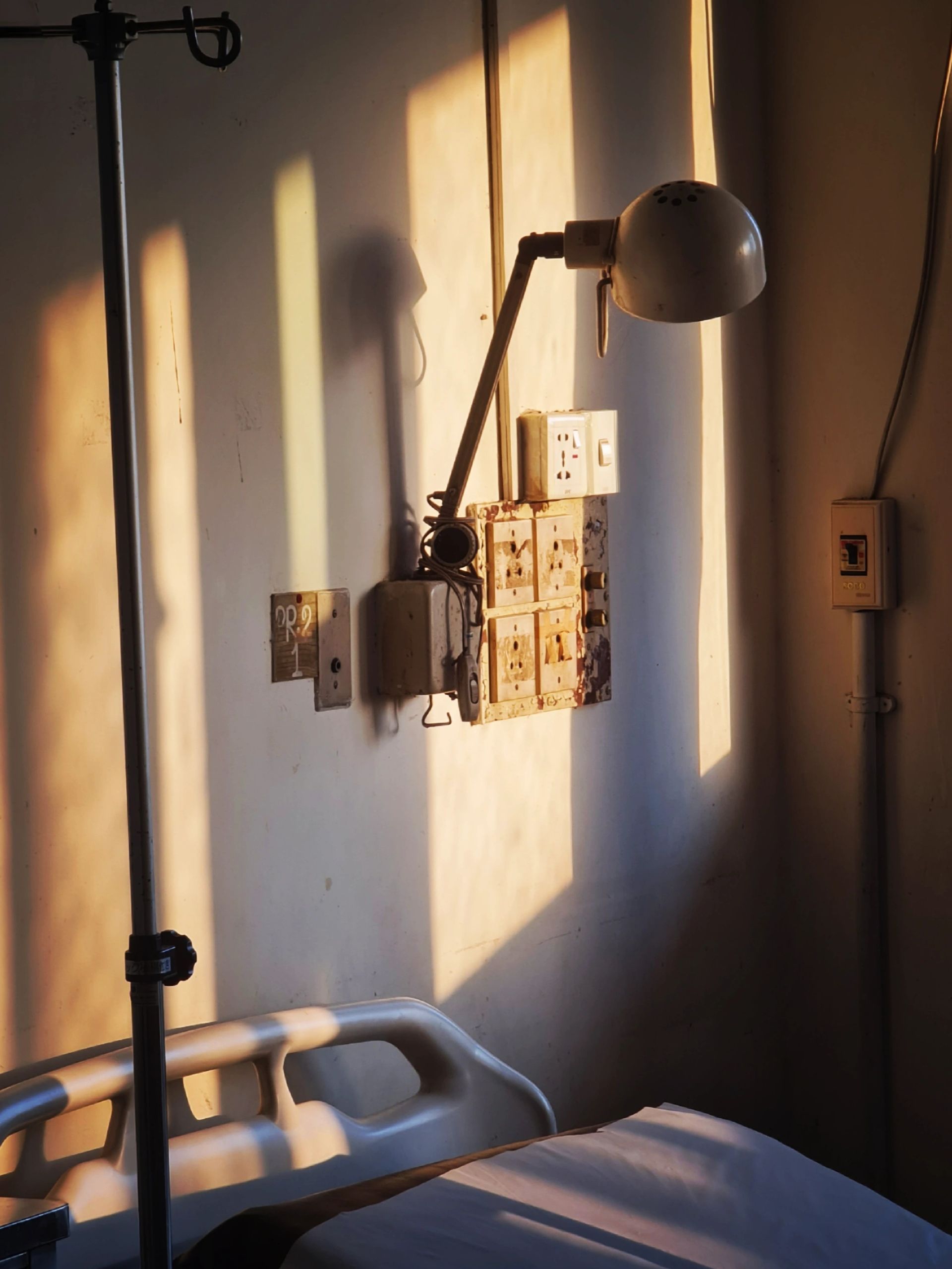 Preconception care in low-resource healthcare settings Empty hospital bed and basic medical equipment in a healthcare facility with limited resources.