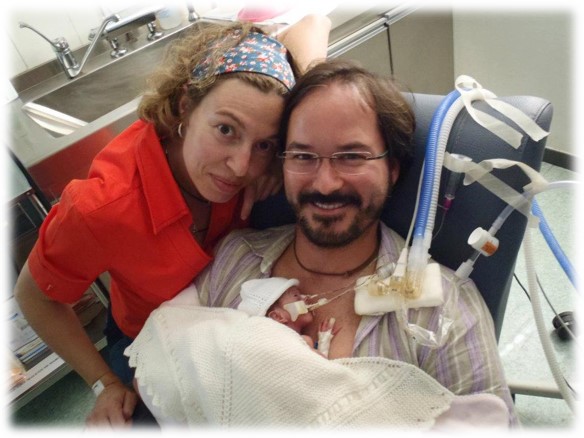 Family Skin-to-Skin Care for a Preterm Infant Parents with a preterm infant resting on the father’s chest while receiving respiratory support.