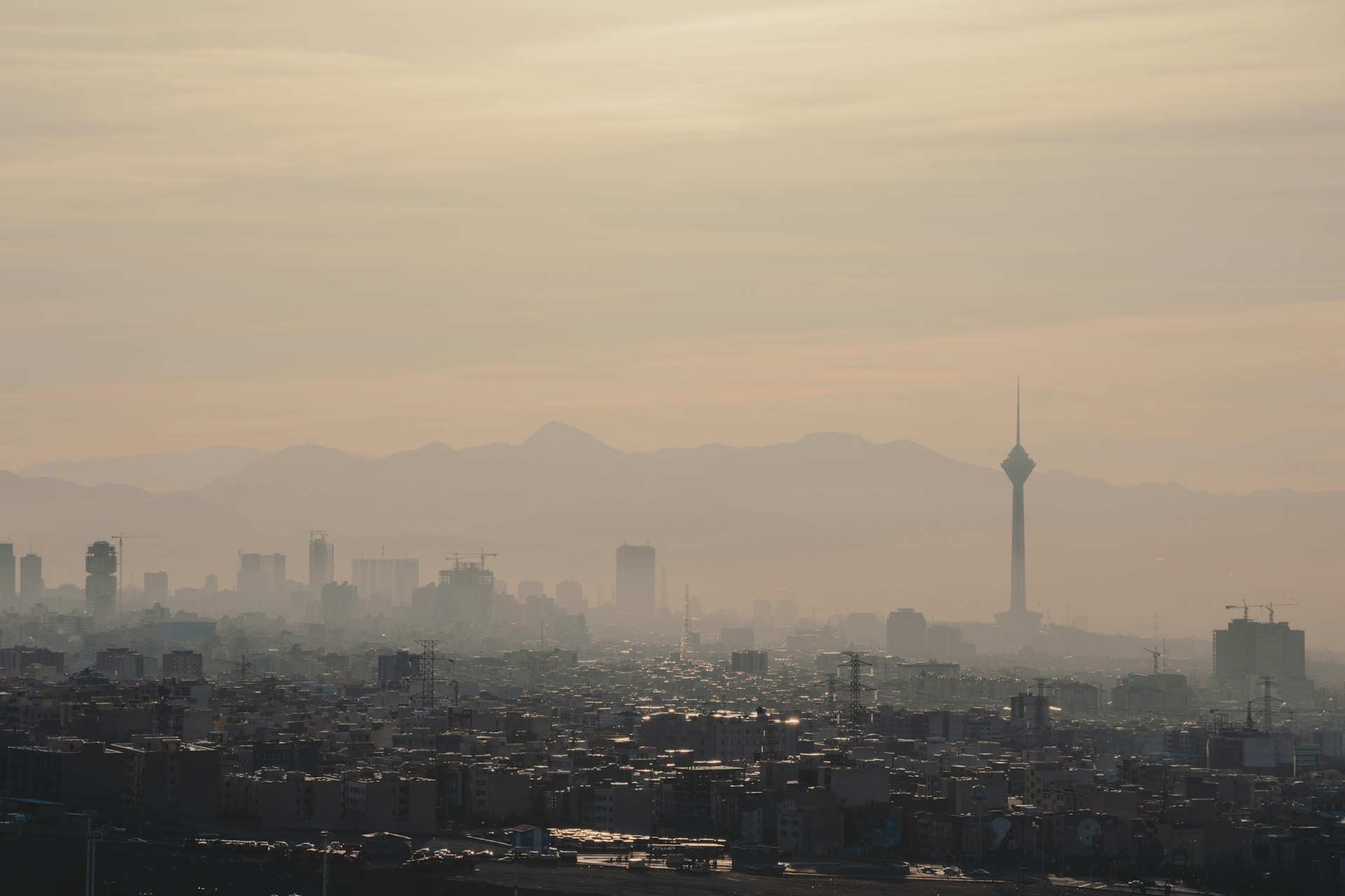 Air Pollution and the Risk of Preterm Birth Smog-covered city skyline with buildings, mountains, and a tall communications tower in the distance.